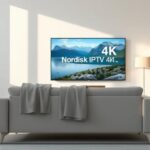 A serene, minimalist living room scene showcasing a 4K television displaying a vibrant Nordic landscape, representing Nordisk IPTV 4K's high-quality visual experience.