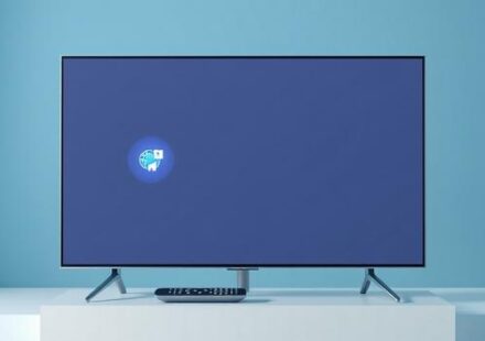 Samsung Smart TV displaying IPTV apps with remote control on a stand.