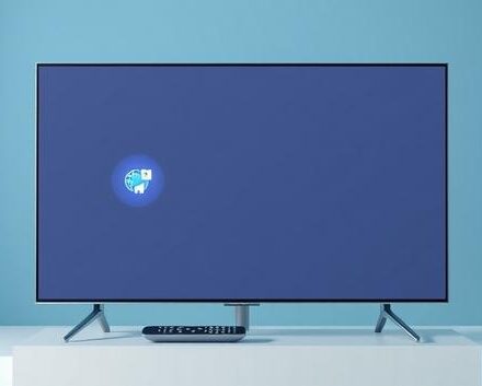 Samsung Smart TV displaying IPTV apps with remote control on a stand.