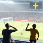 En 3D-illustration av en person som tittar på fotboll på en TV med en stabil IPTV-anslutning